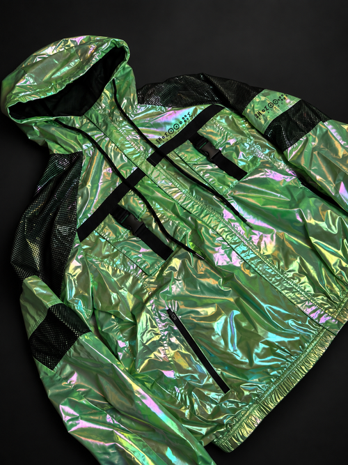 ELAISSAOUI PARA DIZA jacket laid at an angle, showing the front zipper, black straps and iridescent shell.