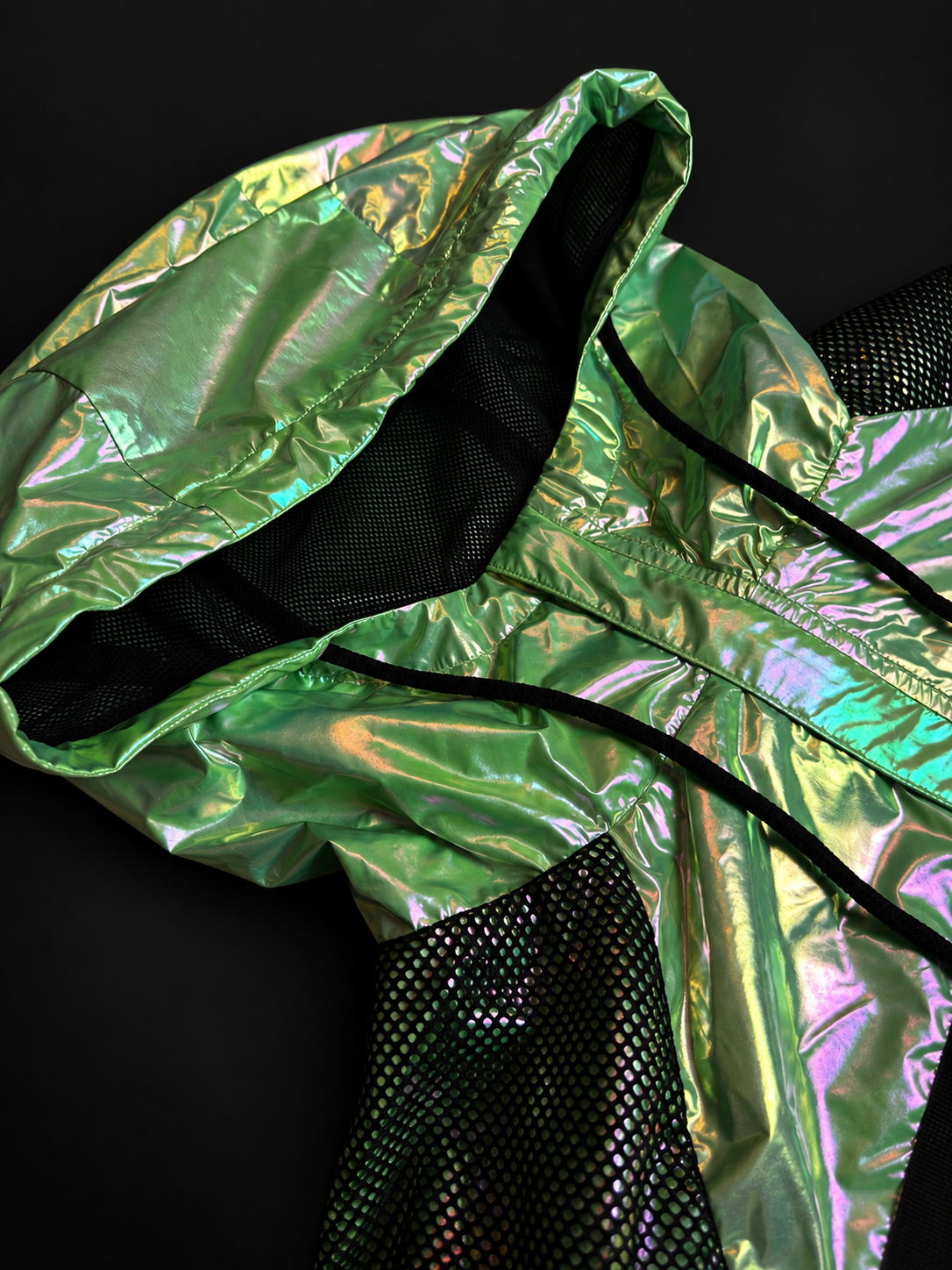 ELAISSAOUI PARA DIZA hood and neckline detail with black drawcords and mesh panels.