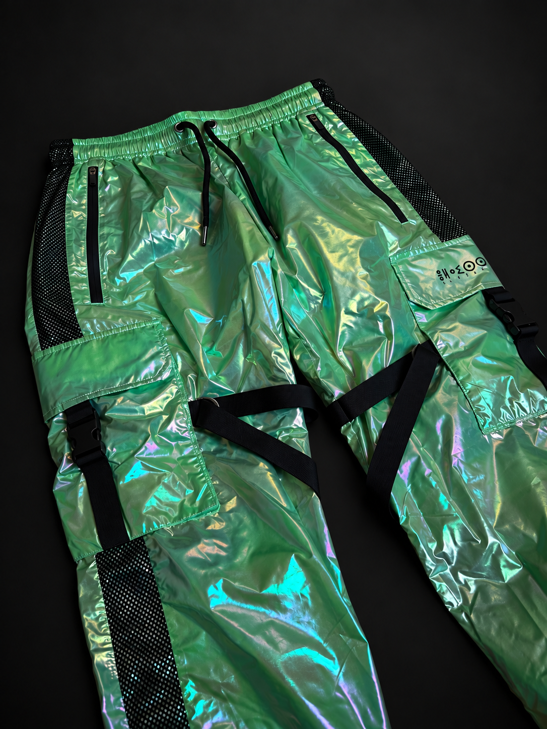 Angled front view of ELAISSAOUI PARA DIZA trousers showing cargo pockets and crossing black straps.