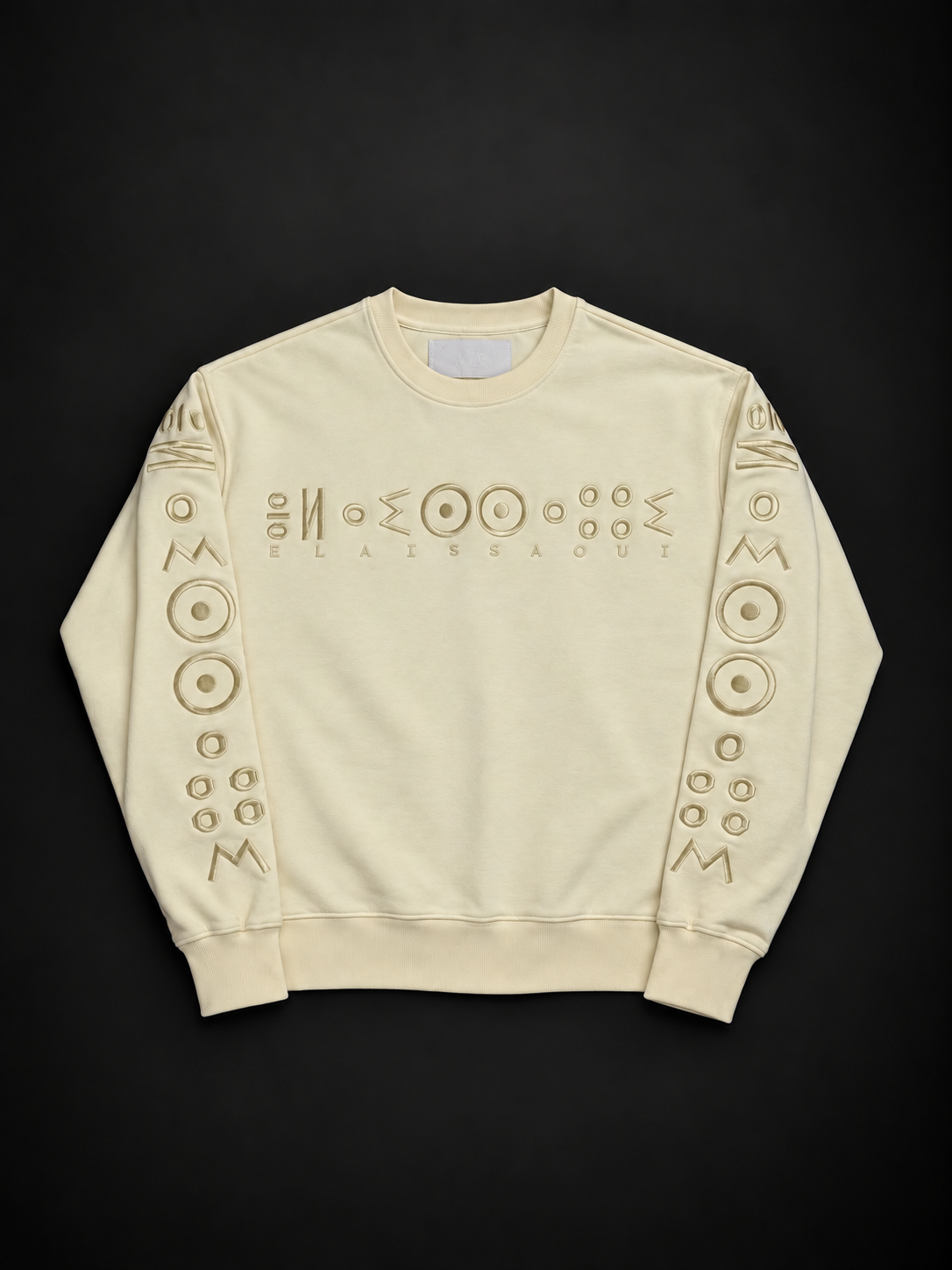 ELAISSAOUI TICHKA heavyweight pullover in Desert Ivory, front view with raised tonal House embroidery on chest and sleeves.