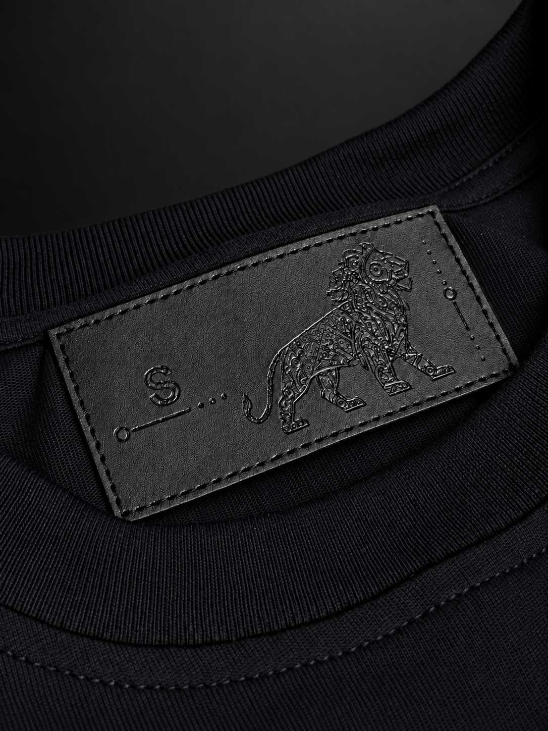 ELAISSAOUI WLAD AISSA ribbed neckline and dark interior label with animal motif.